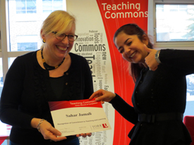 Teaching Commons Director Celia Popovic, left, presents Sahar Jamali with her Record of Completion