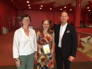 photo of Theatre Department Chair Elizabeth Asselstine (left) and AMPD Dean Shawn Brixey (right) stand with Professor Laura Levin, recipient of the 2015 School of the Arts, Media, Performance & Design Senior Teaching Award