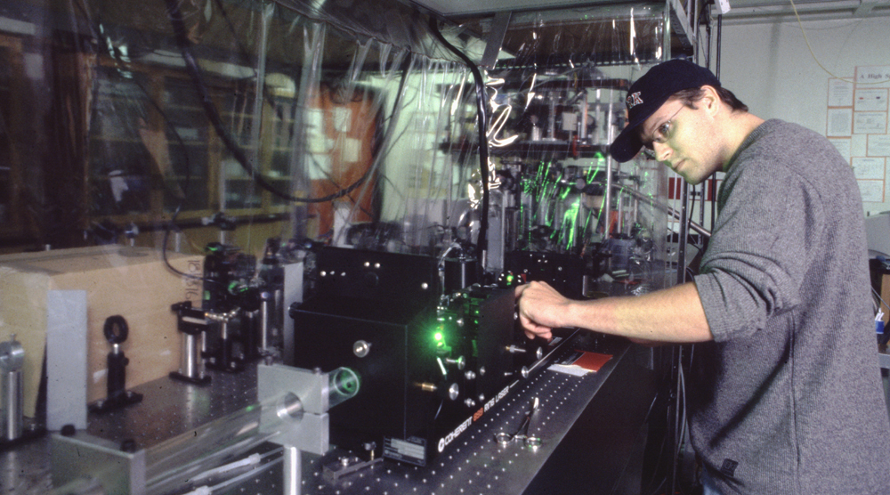 photo of Graduate Student Matthew Weel aligning Titanium:Sapphire Ring Laser