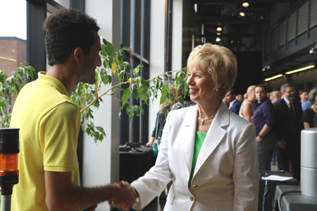 photo of MP Judy Sgro speaking with a student researcher about a VISTA project