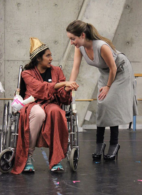 photo of two actors in rehearsal, one in a wheelchair