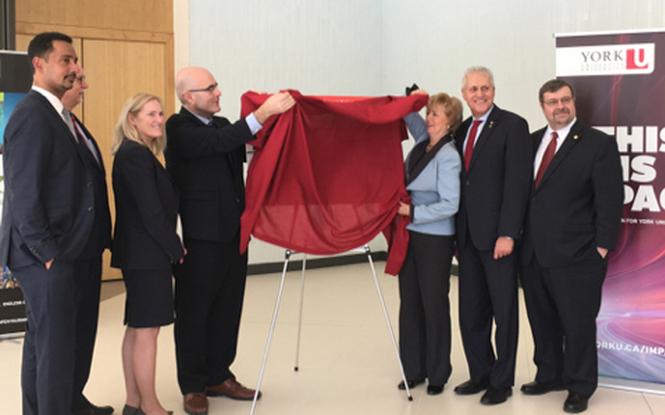 photo of people unveiling images to complement an infrastructure funding announcement