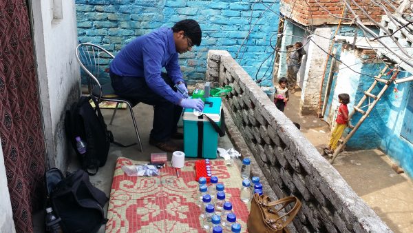 photo of a man performing tests on water