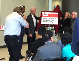 photo of Faculty of Science Dean Ray Jayawardhana with York U Professor Emeritus Allan Carswell, President and Vice-Chancellor Rhonda Lenton and Univeristy Professor Paul Delaney unveil the sign in Allan Carswell’s honour for the new Allan I. Carswell Astronomical Observatory