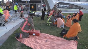 photo of emergency responders treating simulated victims in front of the subway station