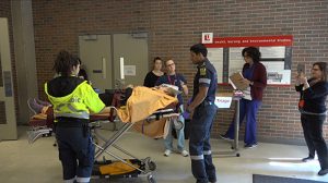 photo of emergency responders with a patient on a gurney