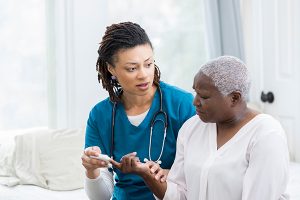 photo of a female nurse talking to a female patient