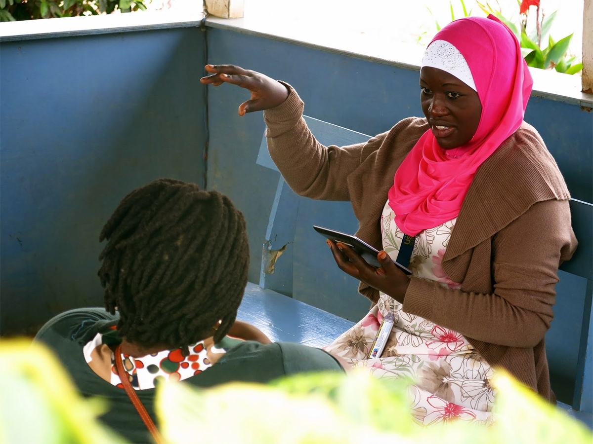 photo of a woman performing a needs assessment in a refugee camp
